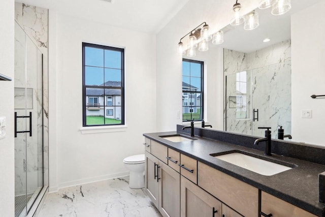 bathroom with vanity, toilet, and an enclosed shower