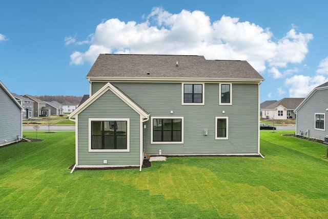 rear view of property with a yard