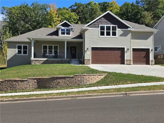 craftsman-style house with a front yard, a garage, and a porch