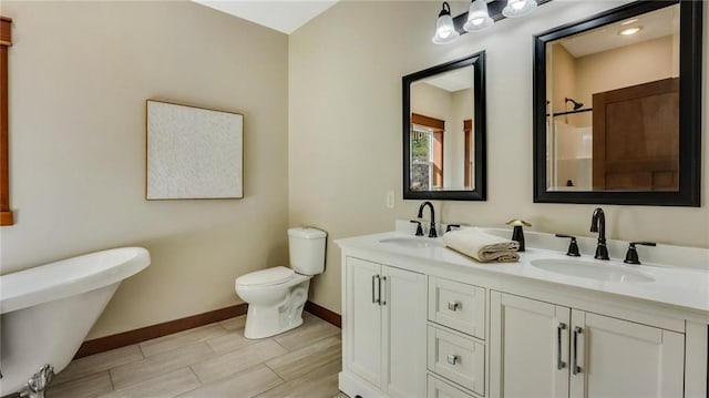 bathroom with hardwood / wood-style flooring, vanity, and toilet