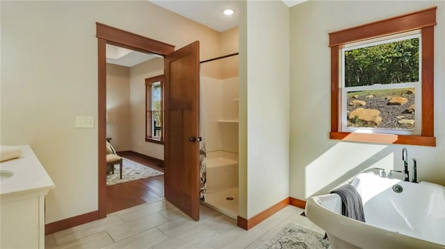 bathroom featuring vanity, shower with separate bathtub, plenty of natural light, and hardwood / wood-style flooring