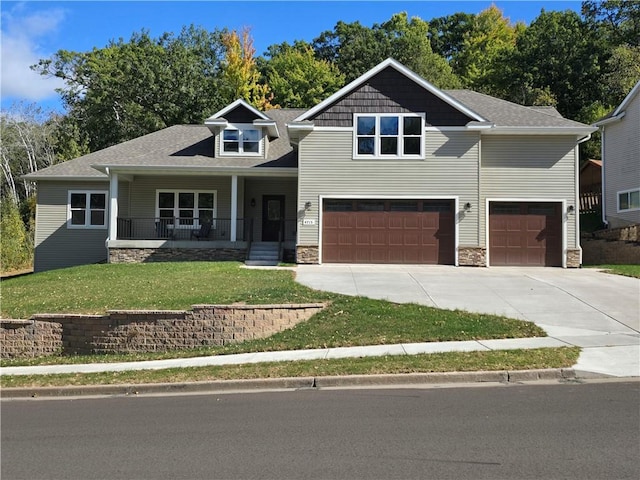 craftsman house with a front lawn, a porch, and a garage