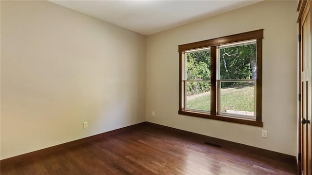 empty room featuring dark hardwood / wood-style flooring