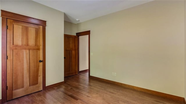 unfurnished bedroom with dark wood-type flooring