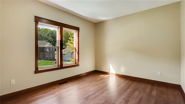 empty room featuring wood-type flooring