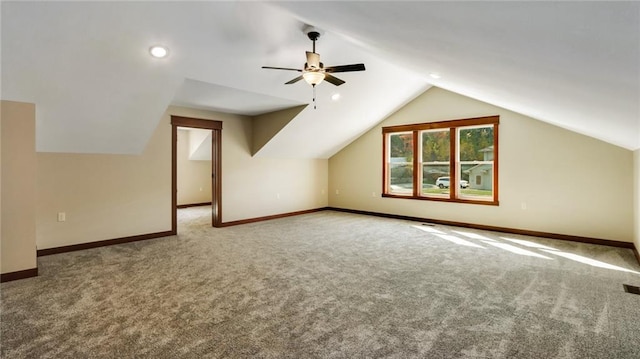 additional living space featuring ceiling fan, vaulted ceiling, and carpet flooring