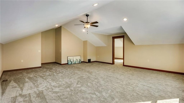 bonus room with lofted ceiling, ceiling fan, and carpet flooring