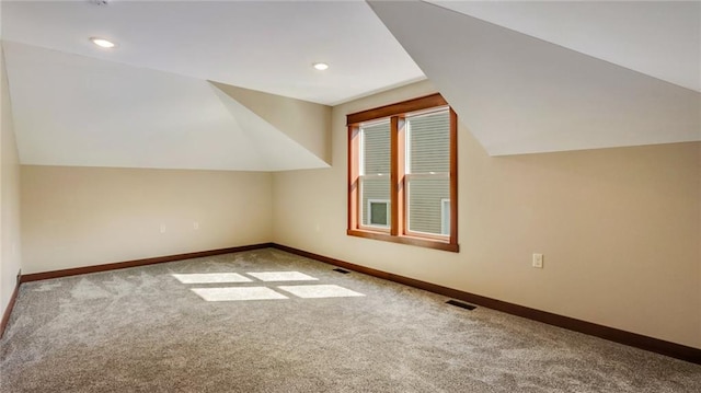 bonus room featuring carpet floors and vaulted ceiling