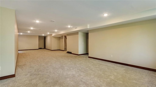 basement featuring light carpet