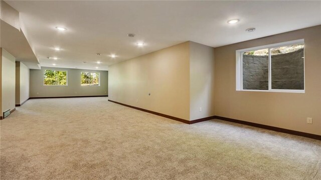 unfurnished room with light carpet