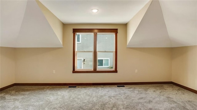 bonus room with light colored carpet