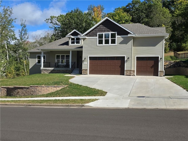 craftsman house featuring a garage, a porch, and a front lawn