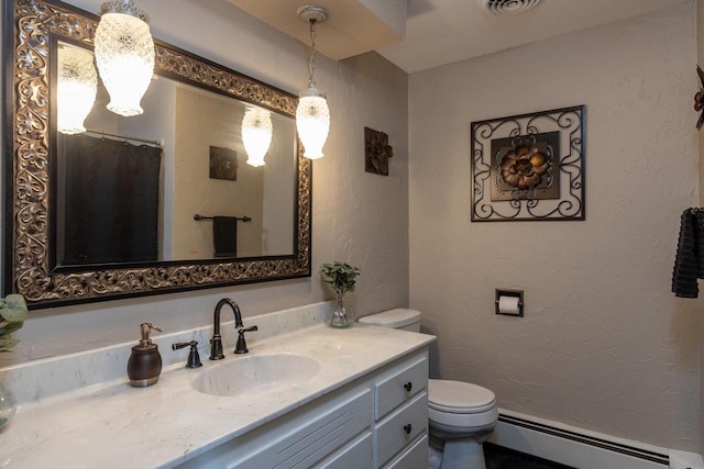 bathroom featuring vanity, a baseboard radiator, and toilet