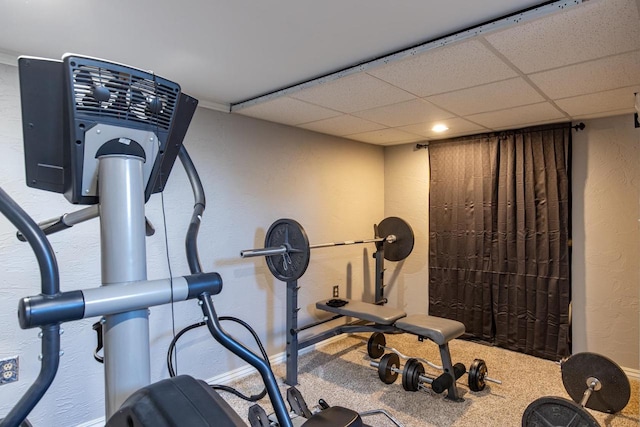 exercise area with a paneled ceiling