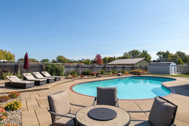 view of pool featuring a storage unit and a patio area