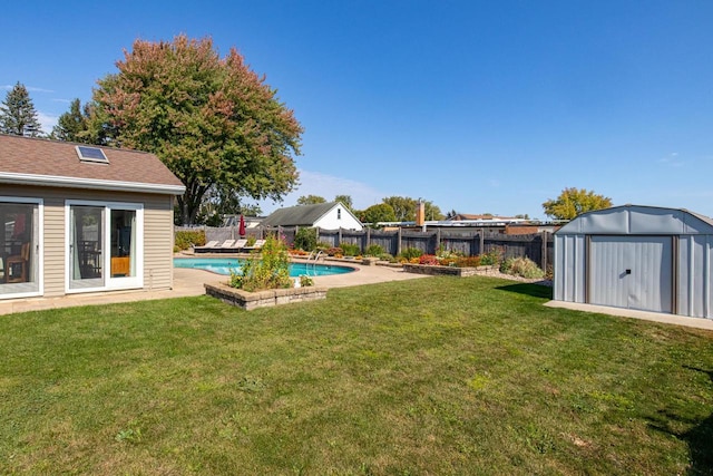 view of yard featuring a fenced in pool and a shed