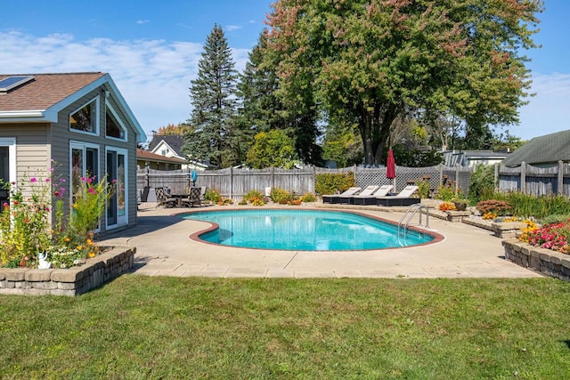 view of swimming pool featuring a patio and a yard