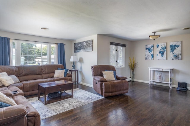 living room with dark wood-type flooring and a baseboard heating unit