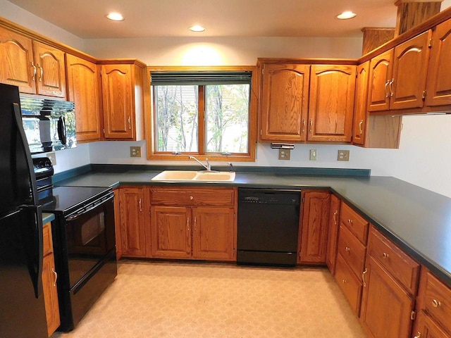 kitchen featuring black appliances, sink, and light colored carpet