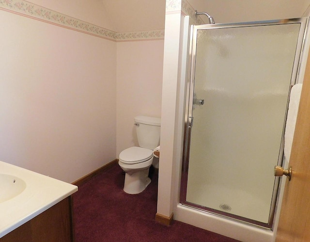 bathroom featuring vanity, toilet, and walk in shower