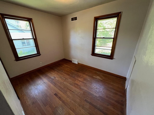 unfurnished room featuring dark wood-type flooring