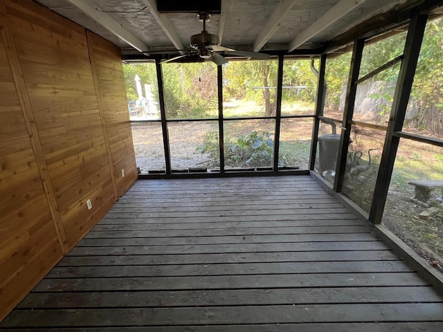 unfurnished sunroom featuring ceiling fan