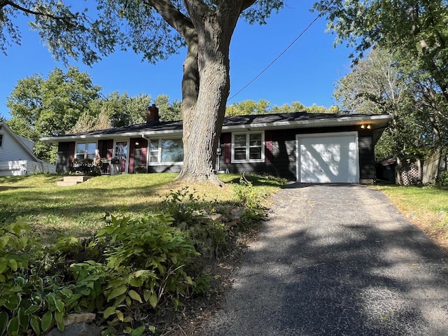 ranch-style home featuring a garage and a front yard