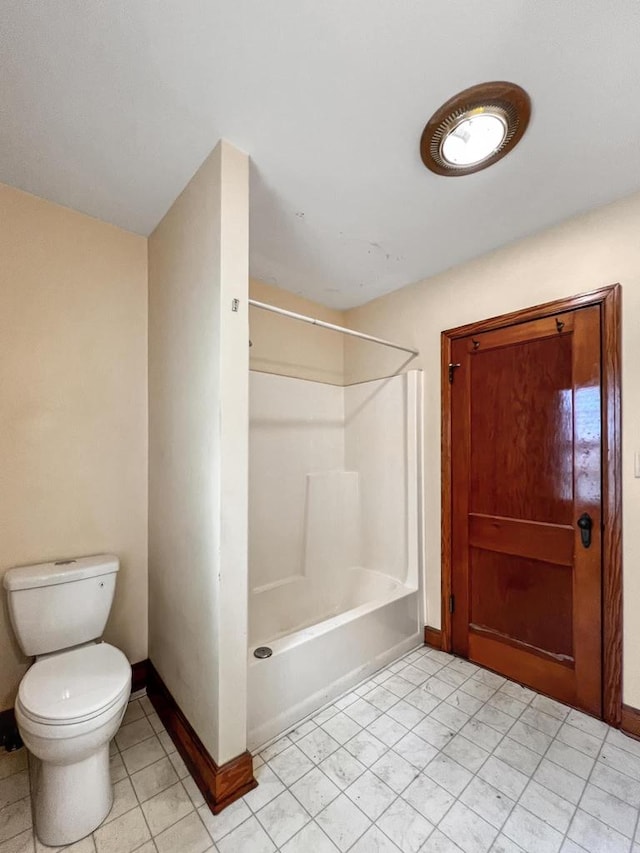 bathroom with tile patterned flooring, toilet, and bathtub / shower combination