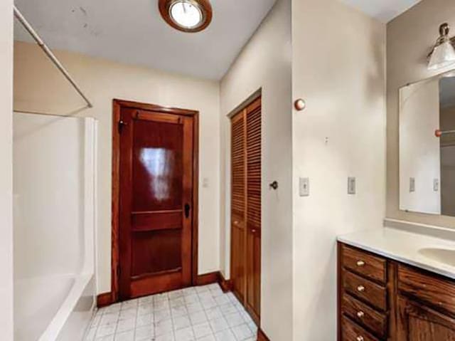 bathroom with bathing tub / shower combination and vanity