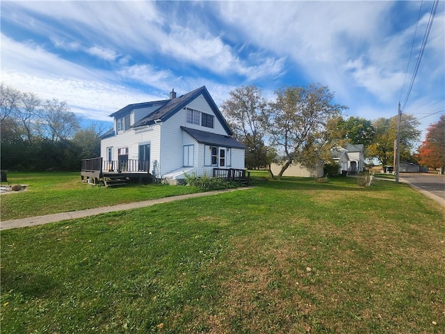 view of side of property with a deck and a yard