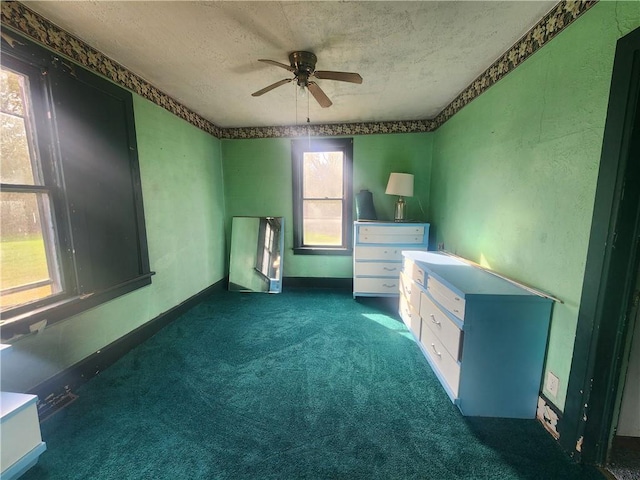 misc room featuring dark carpet and ceiling fan