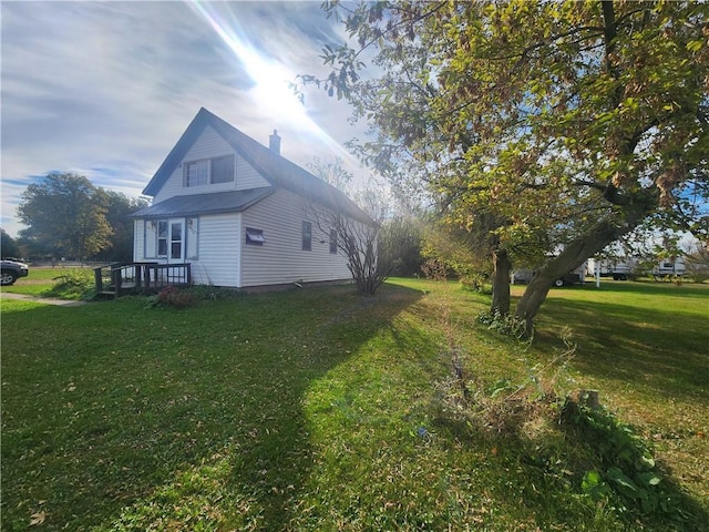 view of side of property with a yard