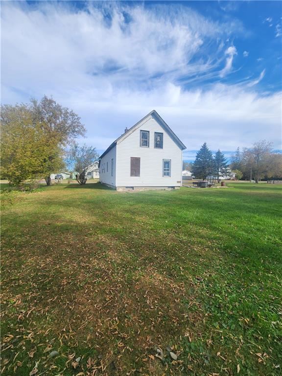 view of side of home featuring a lawn