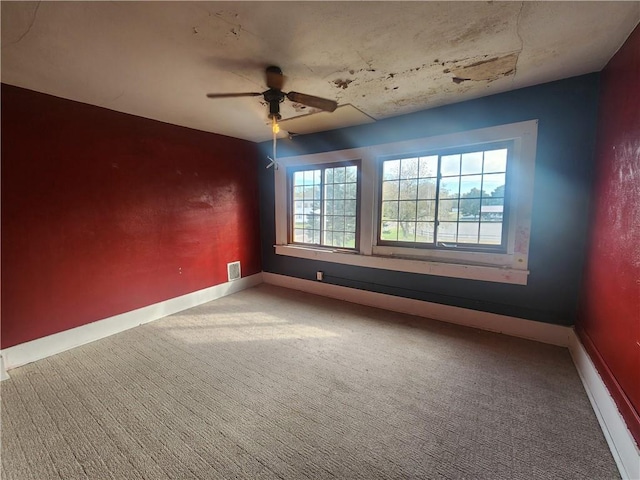 empty room featuring carpet and ceiling fan