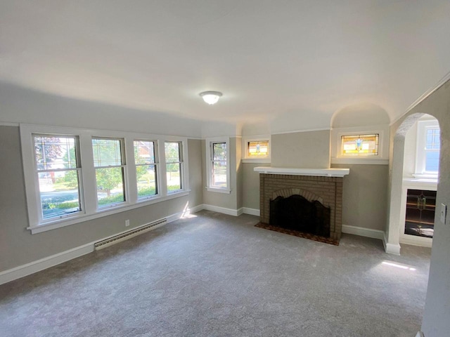 unfurnished living room with carpet, baseboard heating, and a brick fireplace