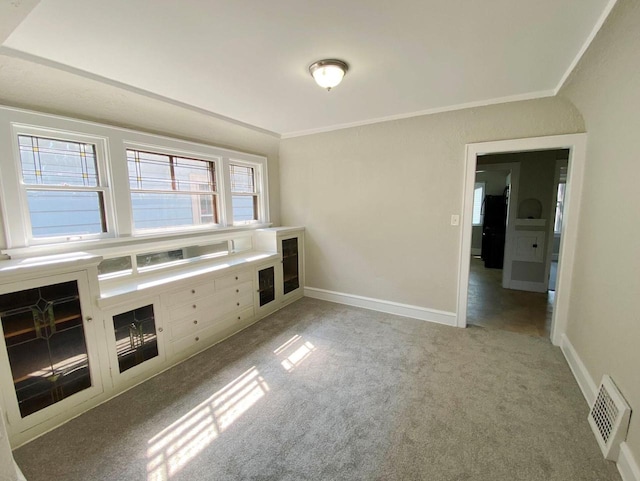 kitchen with light carpet and ornamental molding