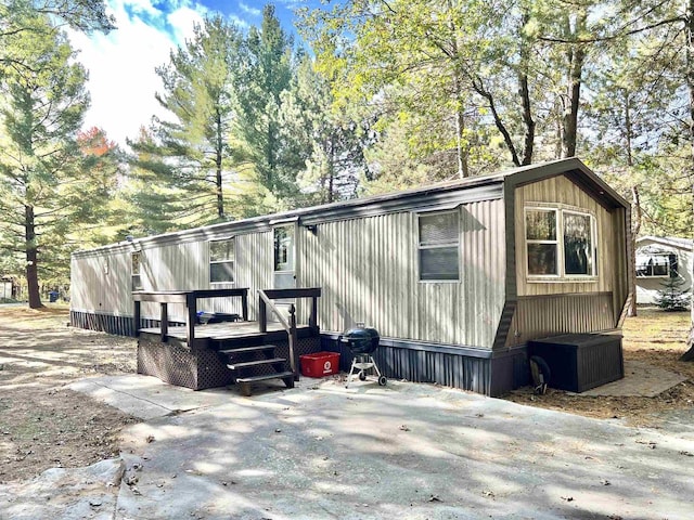 view of side of property featuring a wooden deck