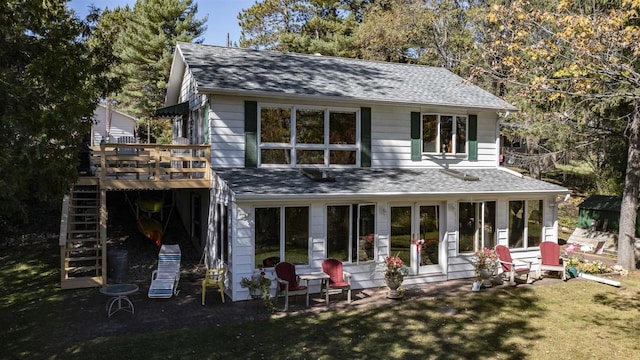 back of house featuring a wooden deck, a yard, and a patio area