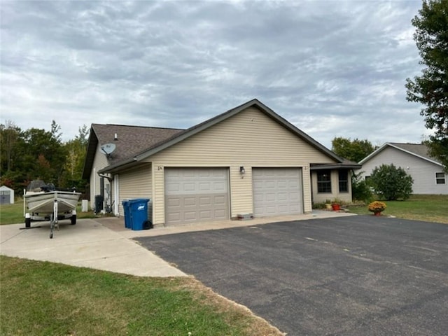 view of property exterior with a lawn and a garage