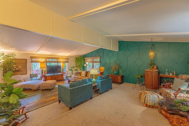 living room featuring carpet flooring, vaulted ceiling, and a wealth of natural light