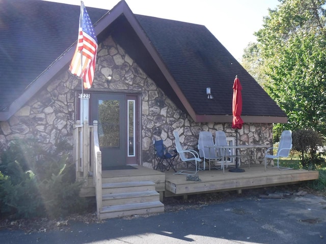 view of exterior entry with a wooden deck