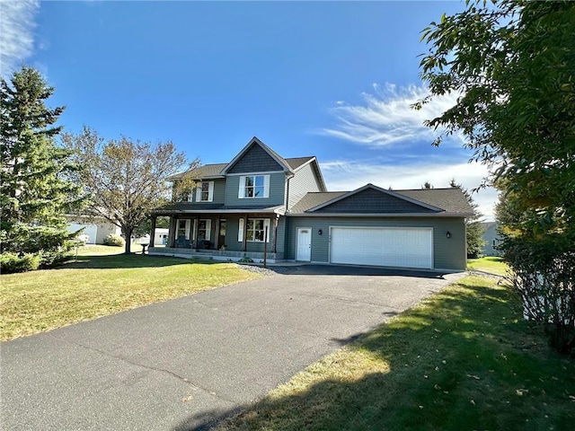 view of front facade with a garage, a porch, and a front yard