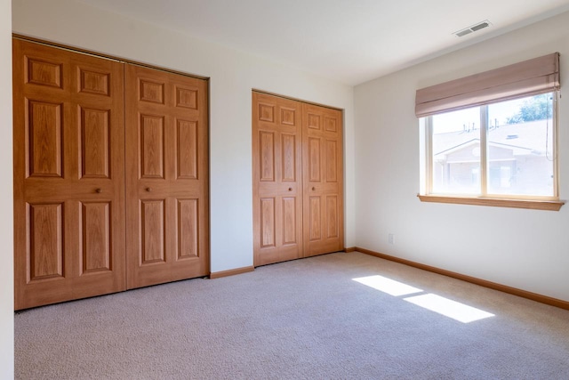 unfurnished bedroom with light colored carpet