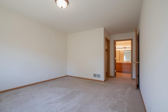 empty room featuring light colored carpet