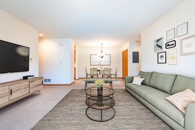 living room featuring electric panel, carpet floors, and a notable chandelier