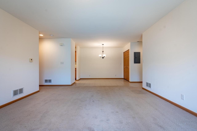 unfurnished room with electric panel, light colored carpet, and a notable chandelier