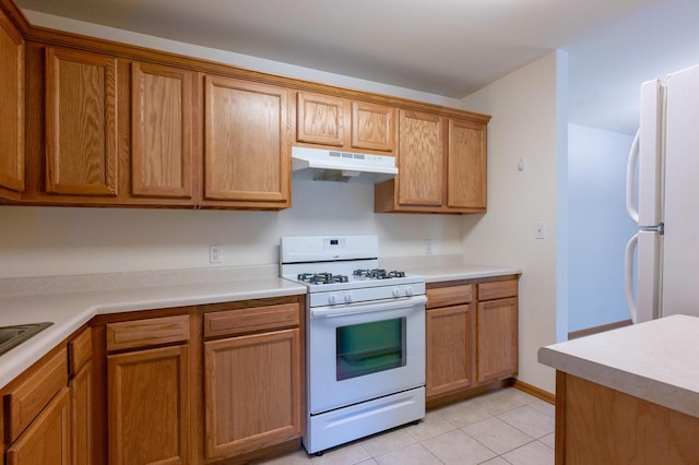 kitchen with light tile patterned flooring and white appliances