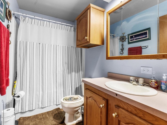 bathroom with curtained shower, vanity, and toilet