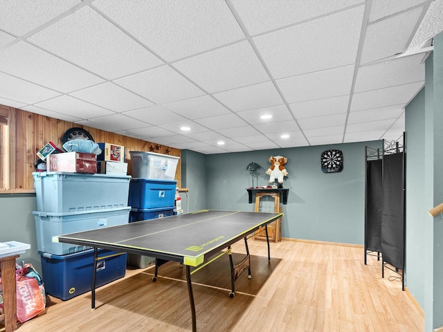 recreation room featuring a drop ceiling and wood-type flooring