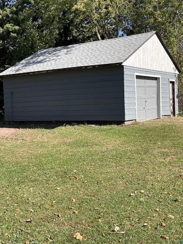 garage with wooden walls and a yard